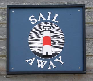Sail Away carved lighthouse sign